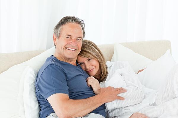 Middle aged couple enjoying a comfortable zoom room bed